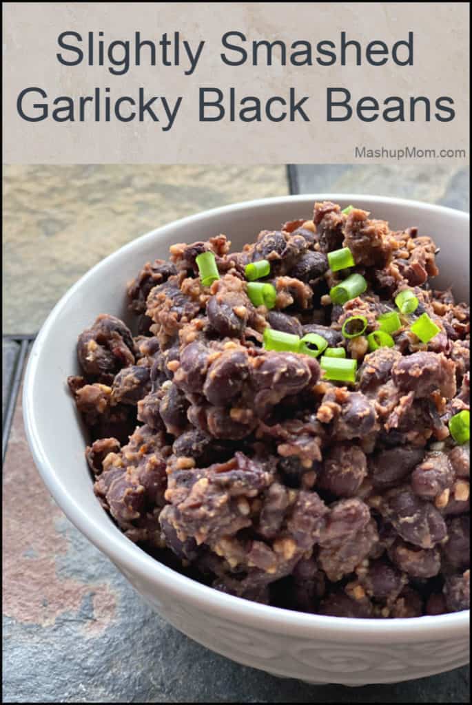 Bowl of slightly smashed garlicky baked beans -- a side dish or burrito filling