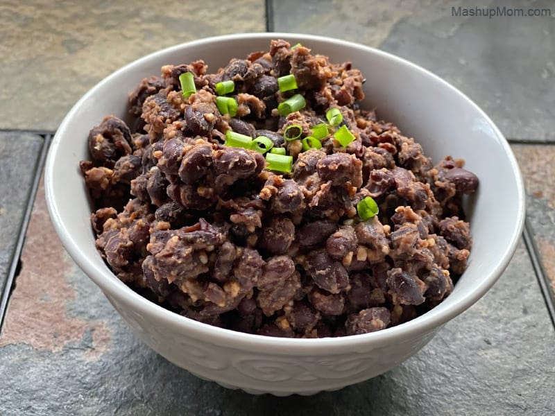 Bowl of slightly smashed garlicky baked beans -- a side dish or burrito filling