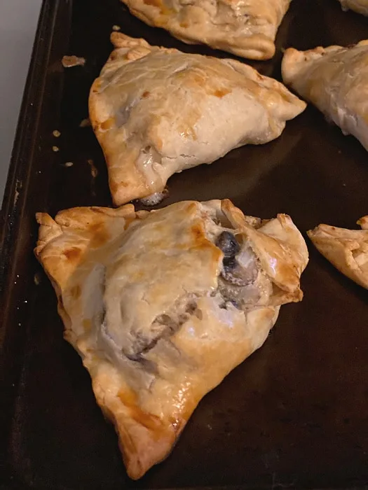 browned hand pies on baking sheet