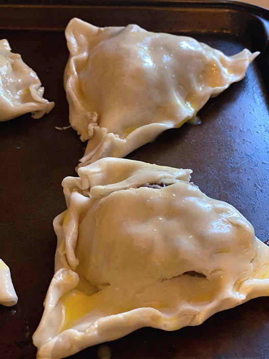 hand pies on a baking sheet with egg wash