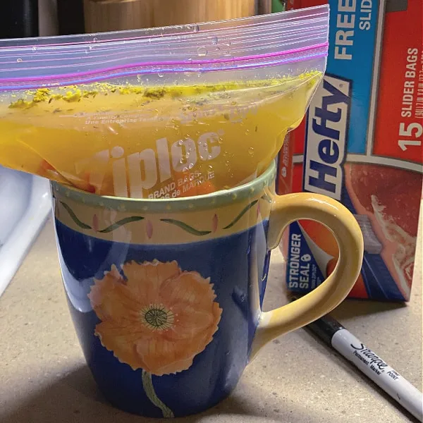 Put freezer bags in a large mug to hold them open