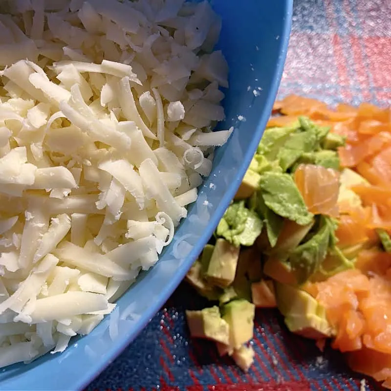 shredded cheese, lox, and avocado