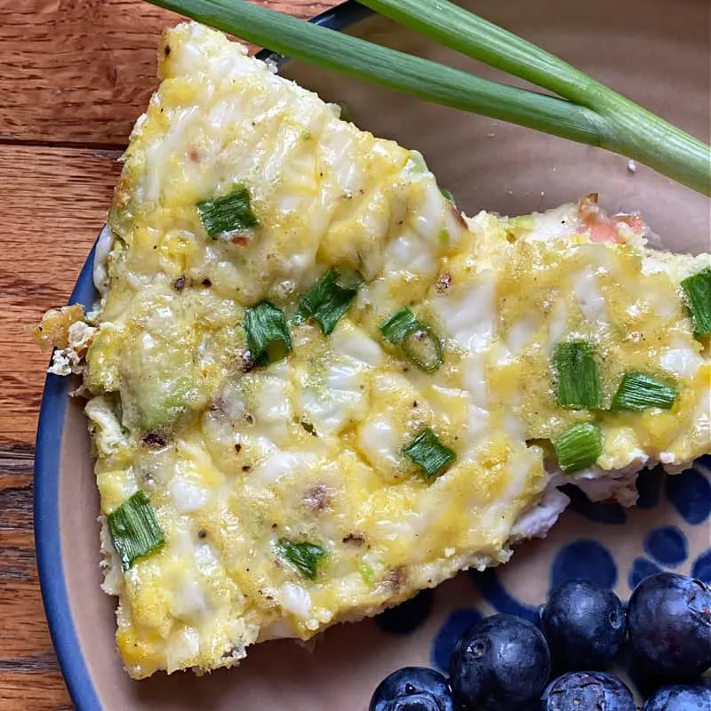 Slice of frittata with smoked salmon, avocado, and ricotta