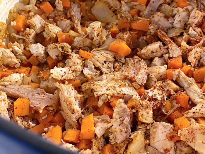 seasoned chicken and carrots in a pot