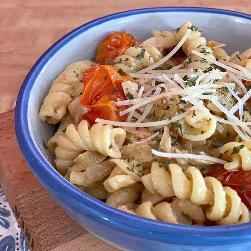 Baked goat cheese and tomato pasta is best topped with Parmesan