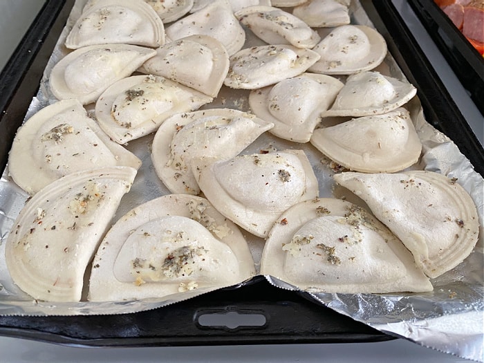 seasoned pierogies on a baking pan