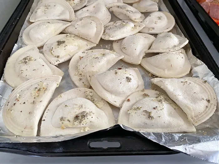 seasoned pierogies on a baking pan