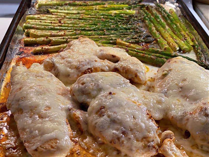 cheesy chicken and asparagus on a sheet pan