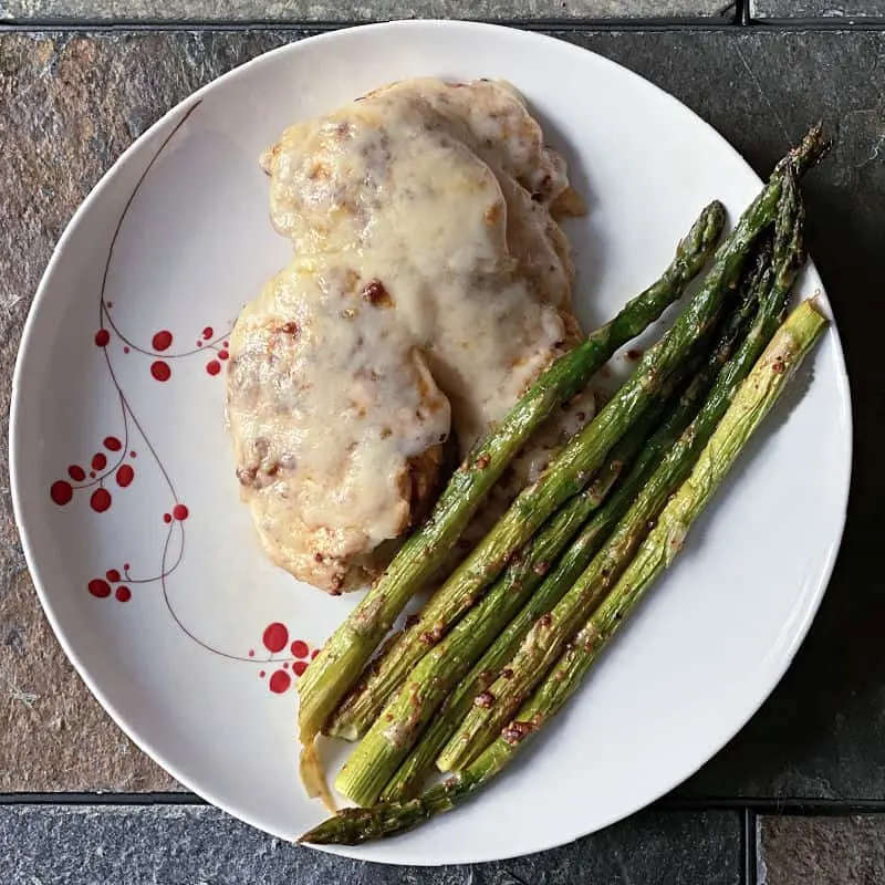 Cheesy chicken and asparagus on a plate