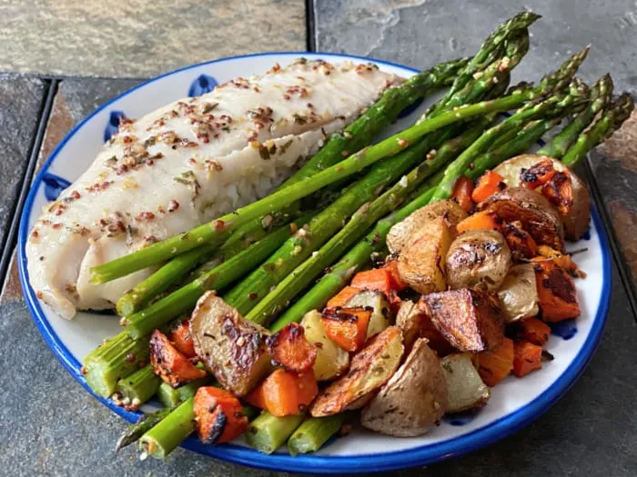 plate of oven baked tilapia and veggies