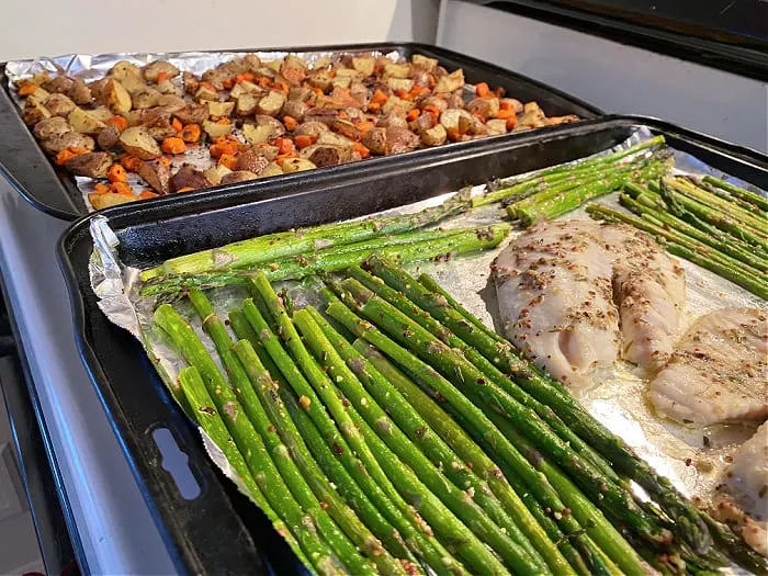 finished fish and veggies on baking sheets