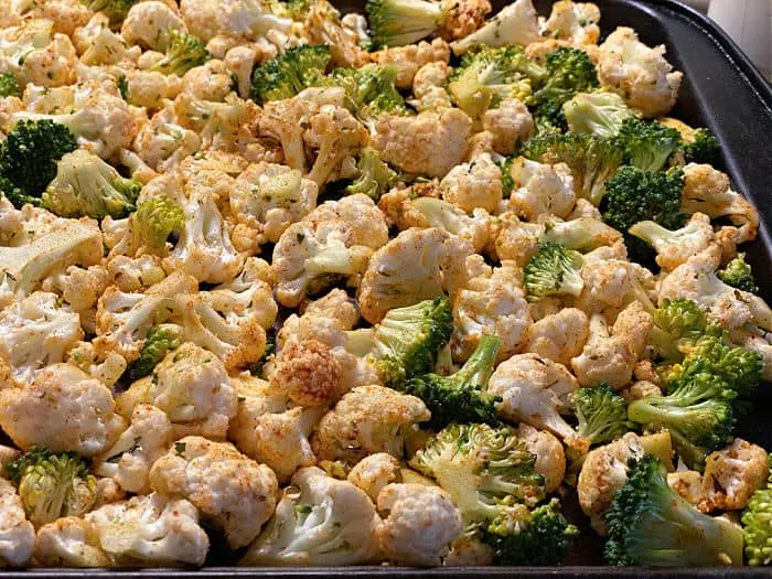seasoned cauliflower and broccoli on a sheet pan