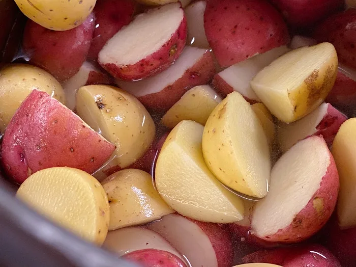 cut up little potatoes in water