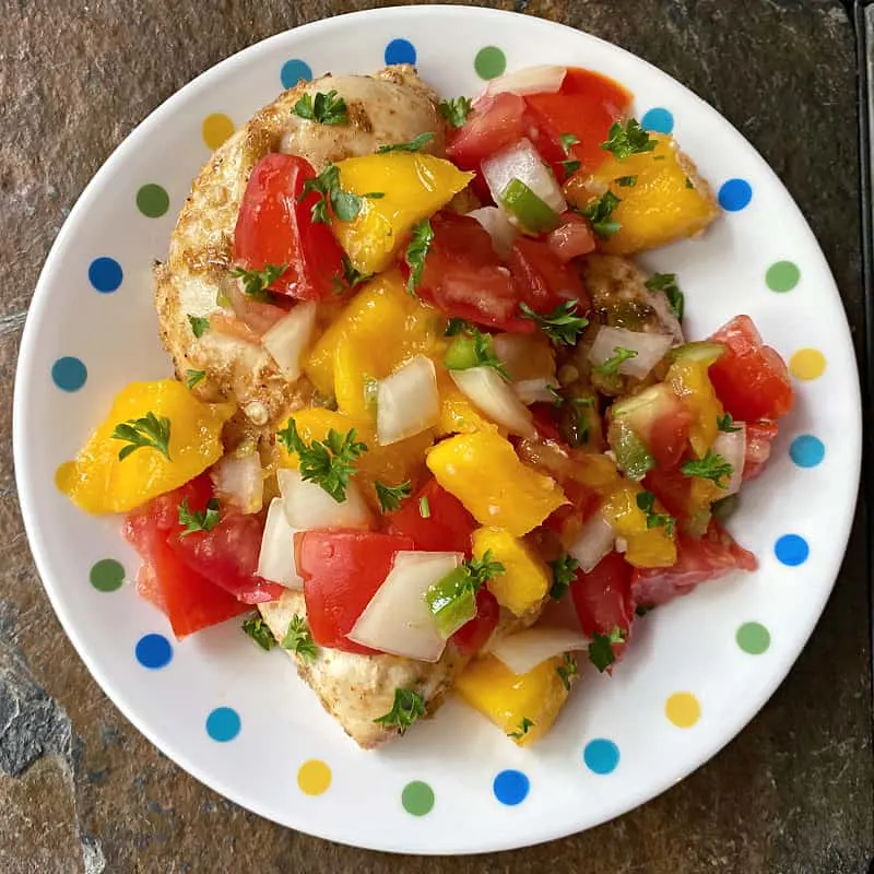 chicken topped with fresh chunky mango-tomato salsa