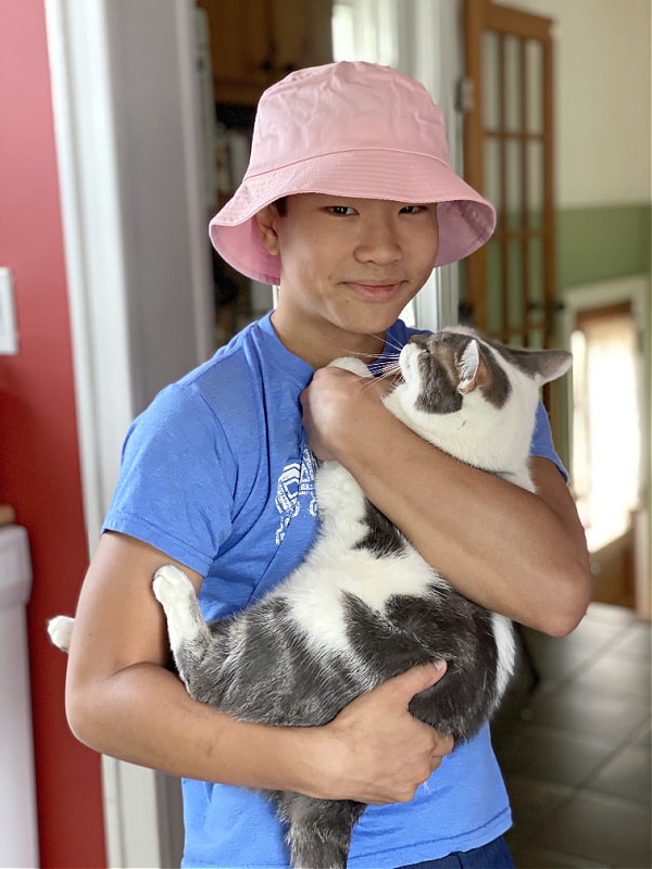 mr.  high school with his cat and a pink hat