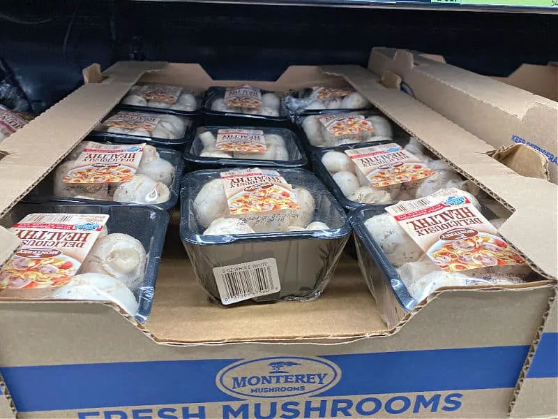 packs of whole mushrooms on the shelf