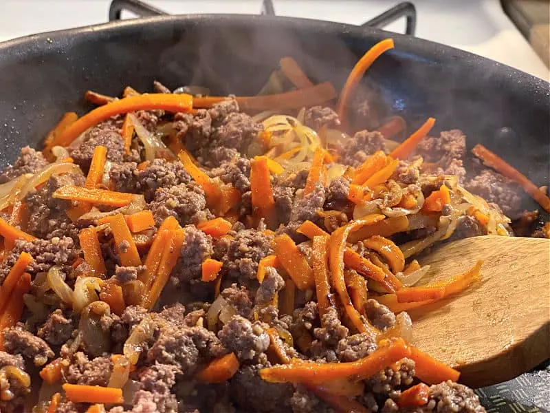 Brown the ground beef with carrots and onion