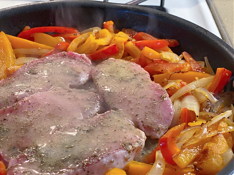 pork chops and peppers in pan