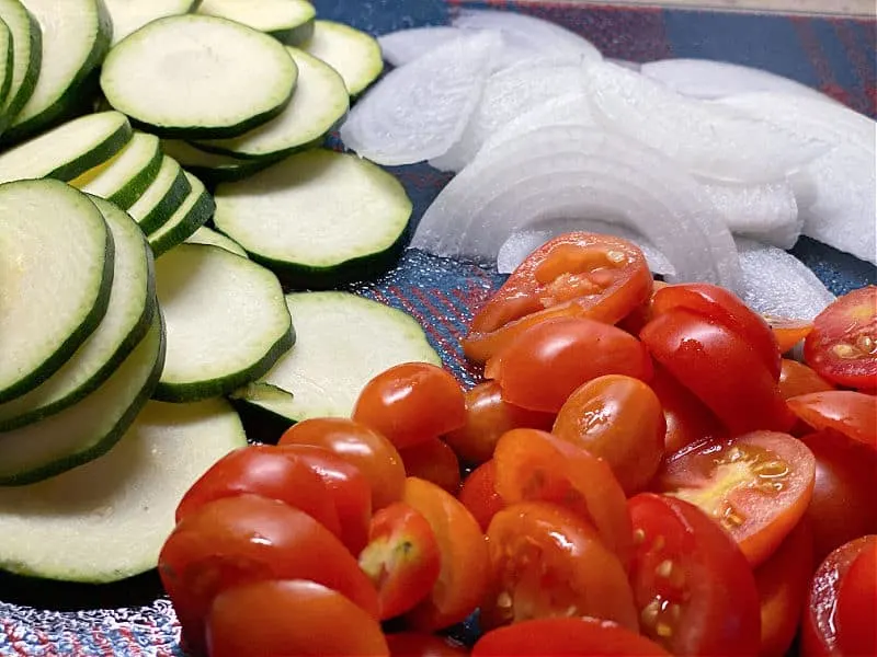 slice up tomatoes zucchini and onion