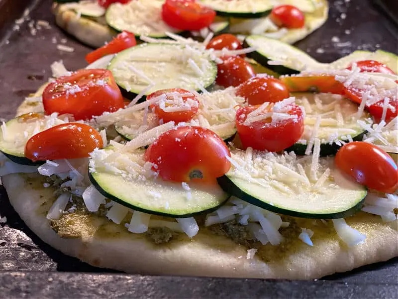 top naan with zucchini and tomatoes