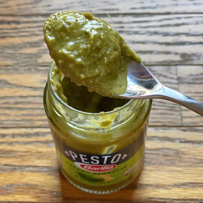 spoon full of pesto on a jar