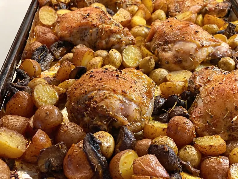 browned chicken and potatoes on pan