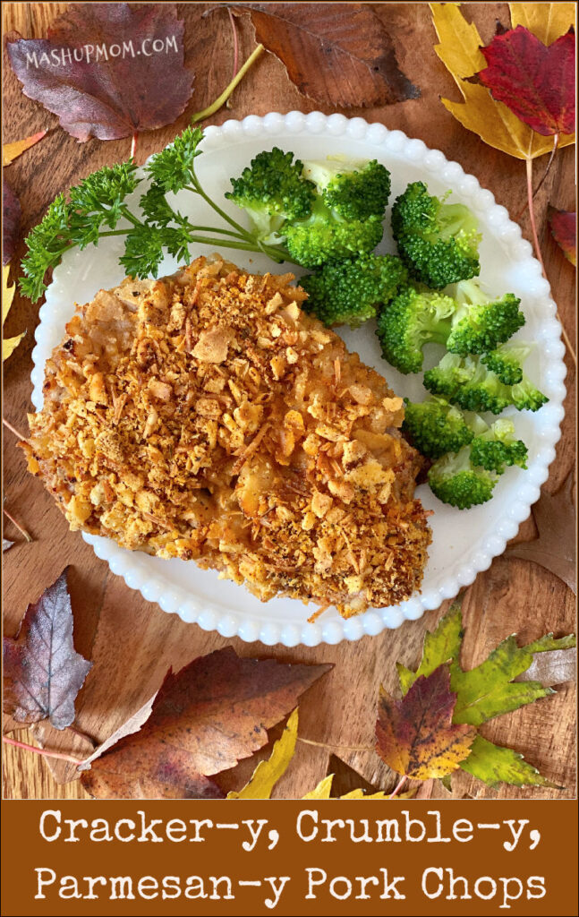 cracker & parmesan baked pork chops on a plate with broccoli and parsley