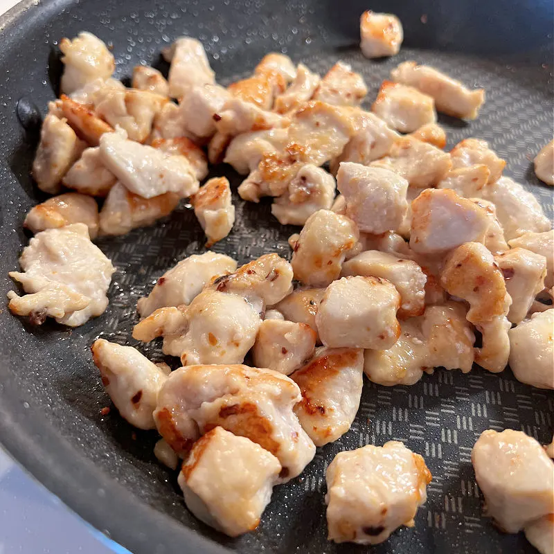 browned chicken pieces in a pan
