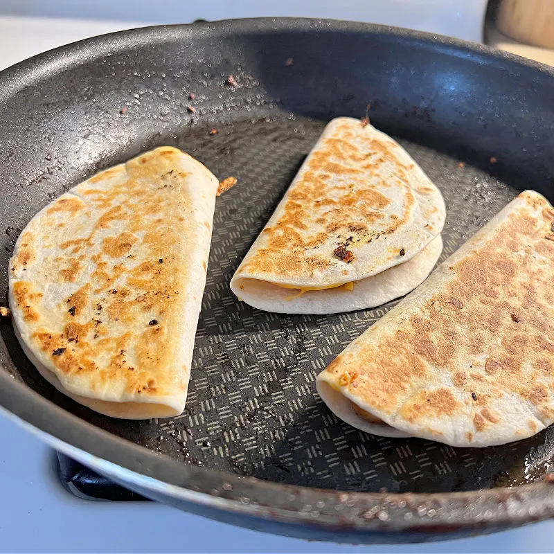 browned quesadillas in a pan