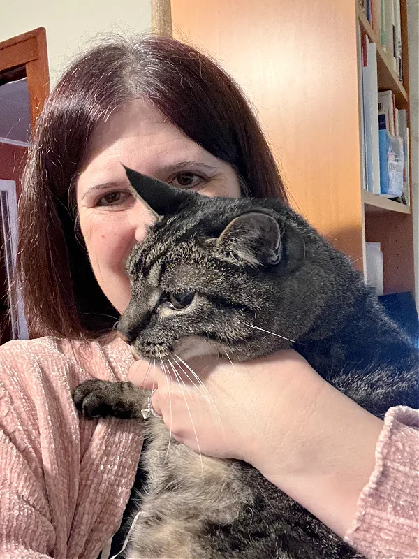 holding a brown cat 