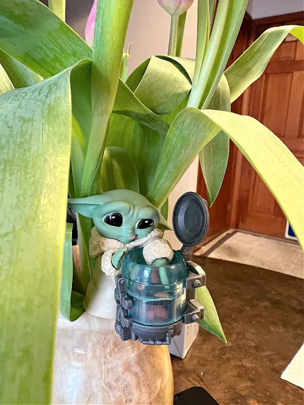 baby yoda figure in tulip vase