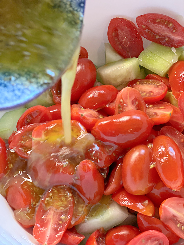 pour lemony dressing on tomatoes and cukes