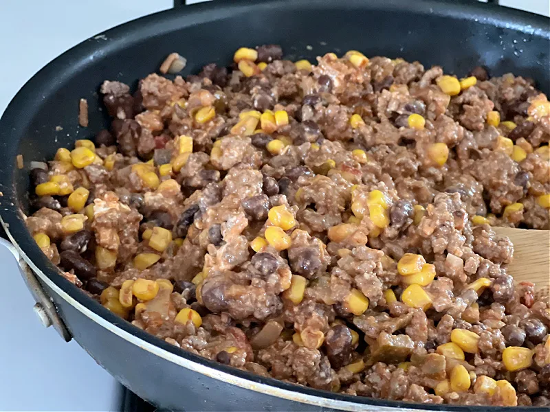 ground beef with cream cheese in the skillet
