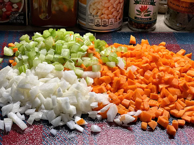 diced onion, carrot, and celery on a cutting board