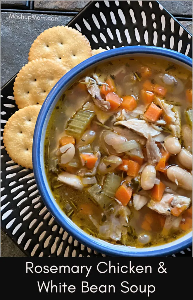 rosemary chicken & white bean soup in a bowl, on a plate with crackers