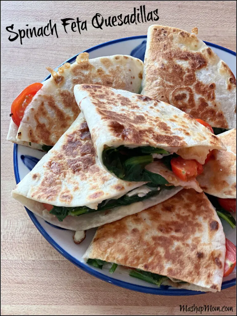 spinach feta and tomato quesadillas on a plate