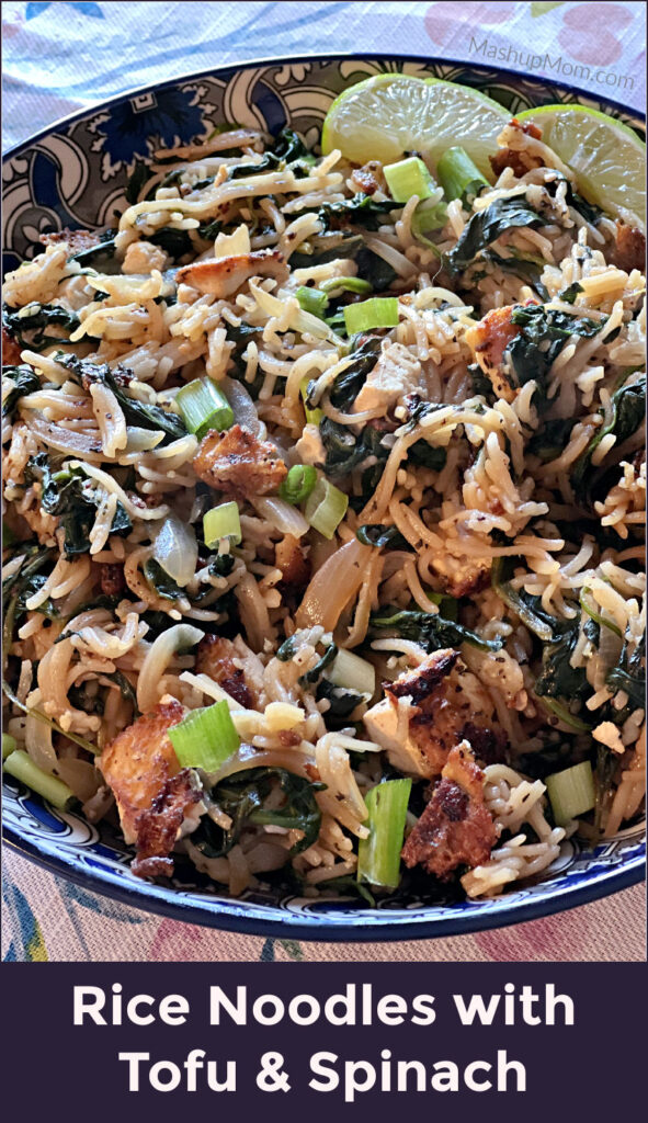 rice noodles with fried tofu and spinach in a bowl