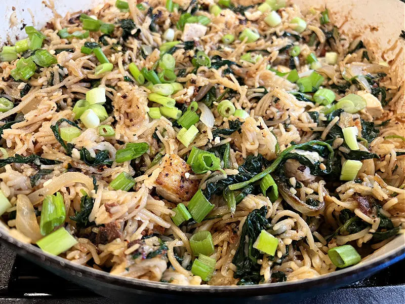 top the pan of noodles with green onions