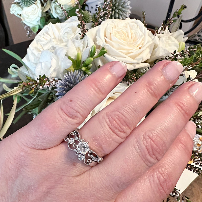 wedding ring on finger with wedding flowers