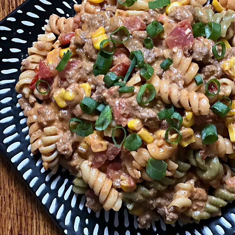 cheesy taco pasta topped with green onions