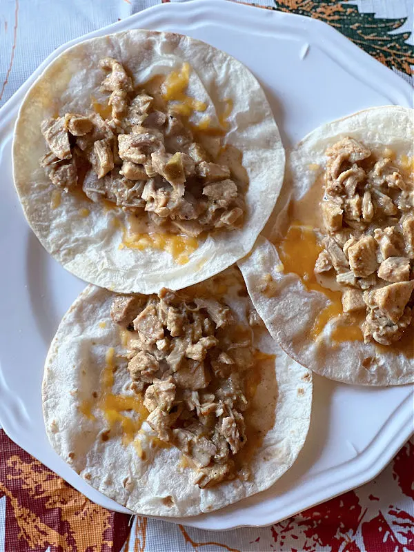 turkey taco filling on cheesy tortillas