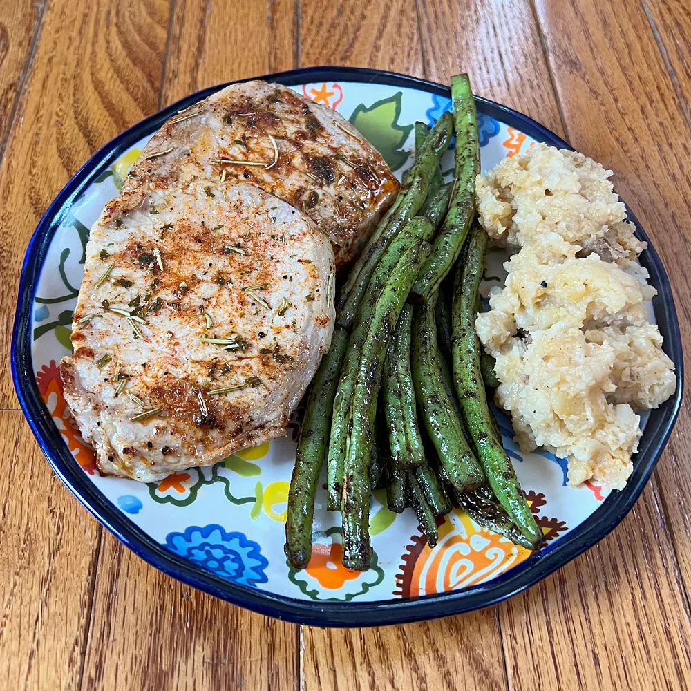 plate of pork chops, green beans, and mashed potatoes