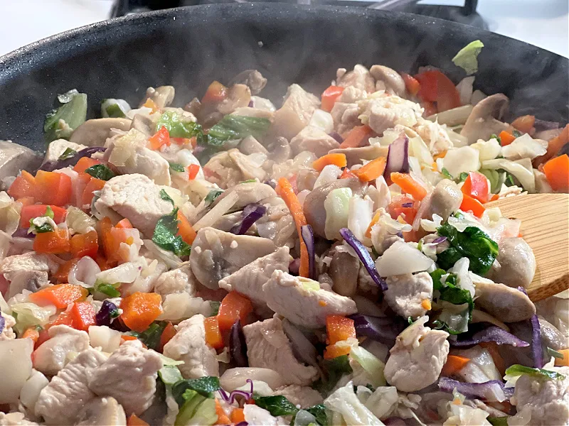 stir in the salad kit veggies