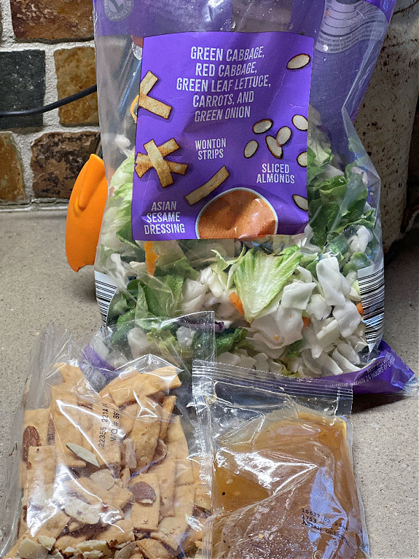 asian salad kit contents -- salad, dressing packet, and wonton almond topping