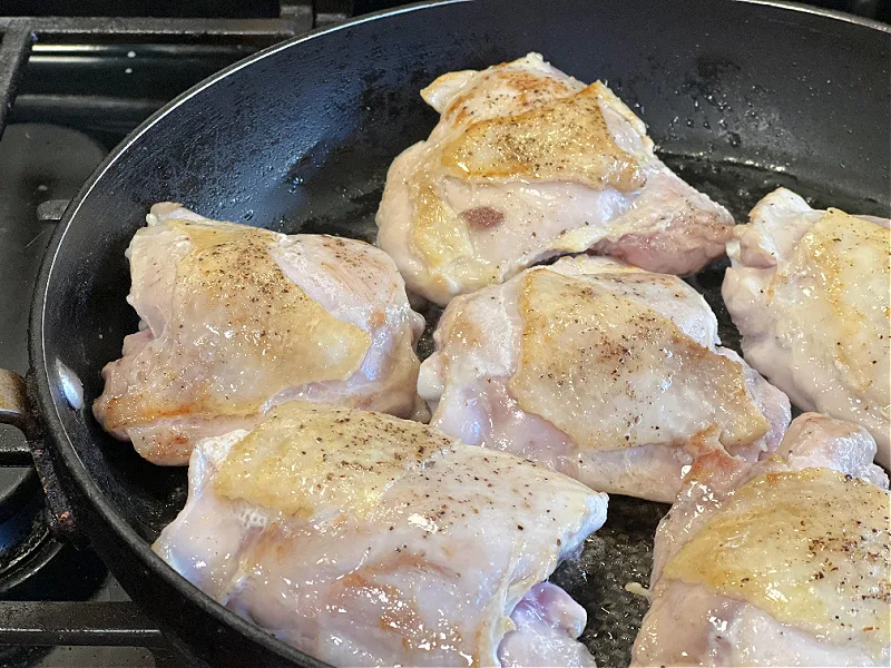 browned chicken in a skillet