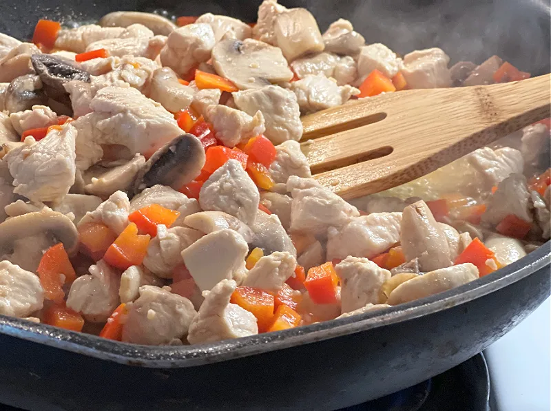 chicken mushrooms and peppers in the pan