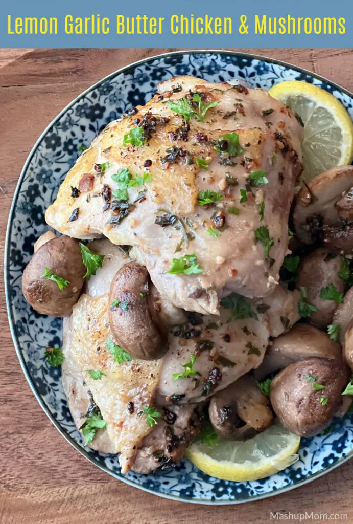 lemon garlic butter chicken thighs and mushrooms on a blue flowered plate