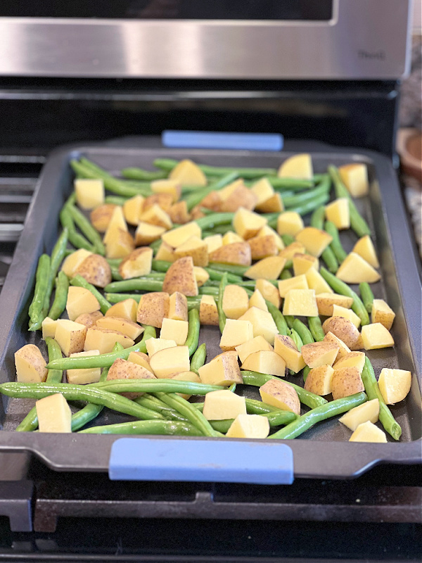 arrange green beans and potatoes on baking pan
