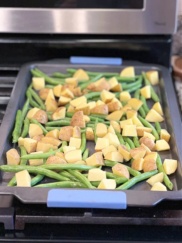 arrange green beans and potatoes on baking pan