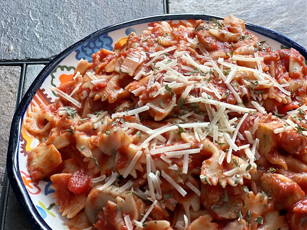 plate of pasta topped with cheese